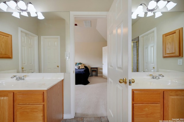 bathroom featuring tile patterned flooring, vanity, and a notable chandelier