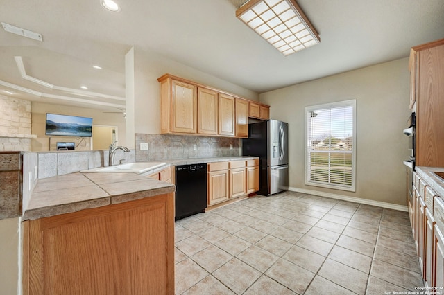 kitchen with sink, kitchen peninsula, decorative backsplash, black dishwasher, and stainless steel fridge with ice dispenser