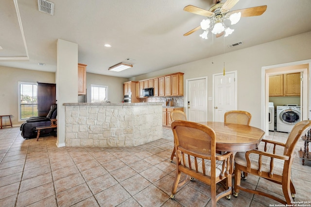 tiled dining room featuring ceiling fan and washing machine and clothes dryer