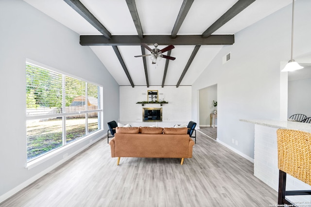 living room with high vaulted ceiling, beamed ceiling, ceiling fan, and light hardwood / wood-style floors