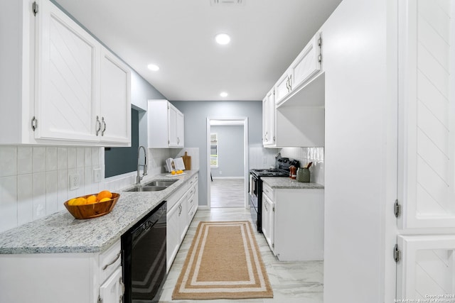 kitchen with black appliances, sink, tasteful backsplash, light stone countertops, and white cabinetry