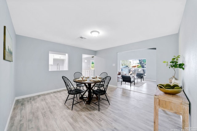 dining space with light hardwood / wood-style floors