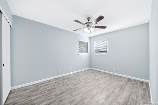 empty room featuring light hardwood / wood-style flooring and ceiling fan