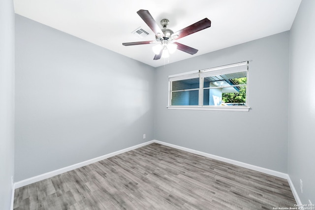 spare room with light wood-type flooring and ceiling fan