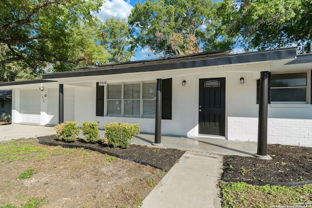 single story home with a garage and a porch