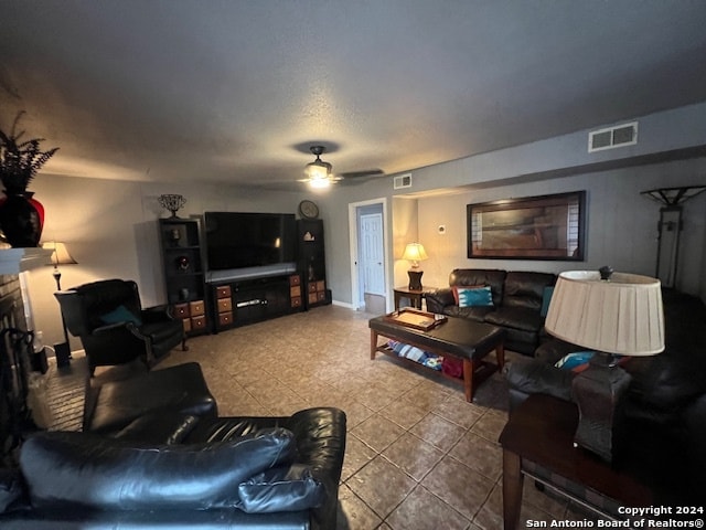 tiled living room with ceiling fan