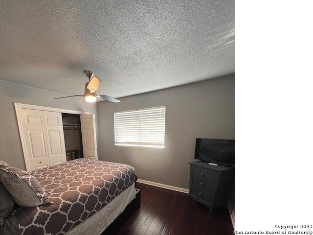 bedroom with dark hardwood / wood-style flooring, a closet, a textured ceiling, and ceiling fan