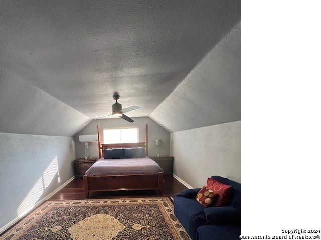 bedroom featuring hardwood / wood-style floors, lofted ceiling, a textured ceiling, and ceiling fan