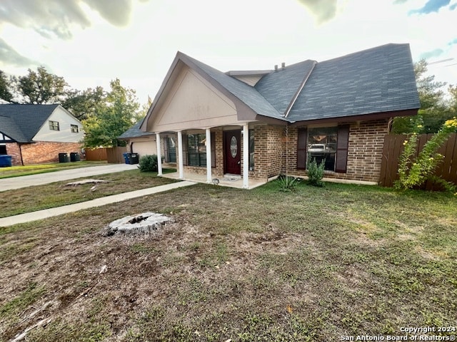 view of front of home with a front yard and a porch