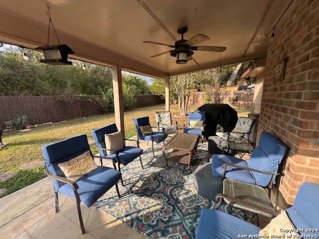 view of patio / terrace with an outdoor living space, grilling area, and ceiling fan