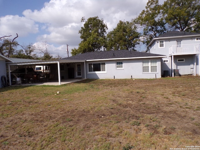 back of house with cooling unit, a patio, and a yard