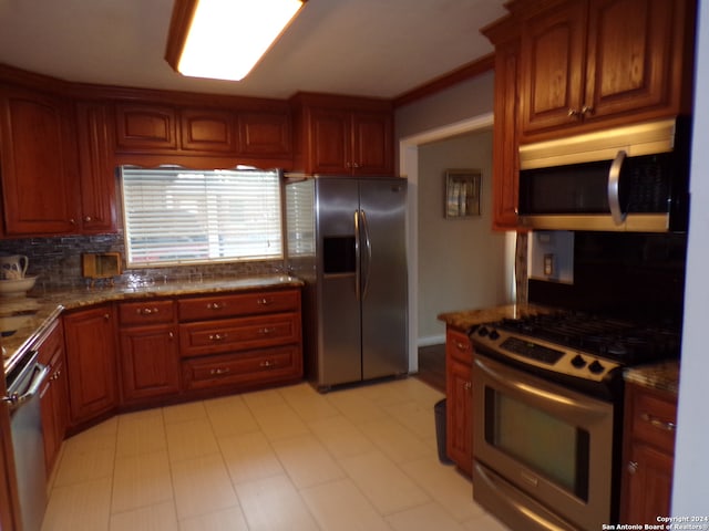 kitchen with stone countertops, decorative backsplash, crown molding, and stainless steel appliances