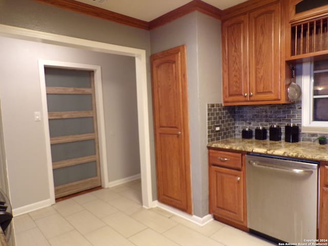 kitchen featuring tasteful backsplash, ornamental molding, light tile patterned floors, light stone countertops, and stainless steel dishwasher