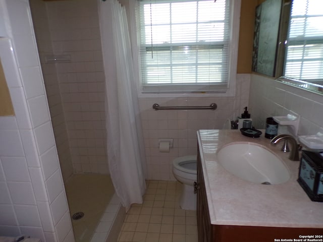 bathroom featuring tile walls, vanity, toilet, and a shower with curtain