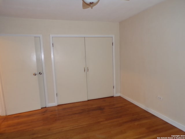 unfurnished bedroom with hardwood / wood-style floors