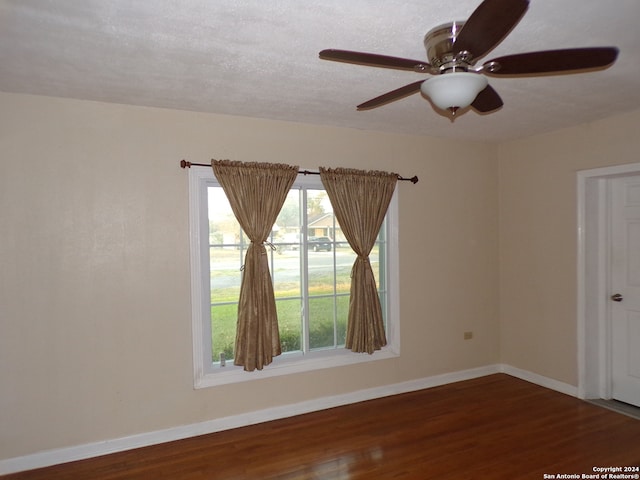 unfurnished room with hardwood / wood-style floors, ceiling fan, and a textured ceiling