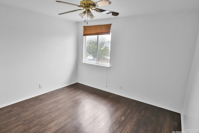 unfurnished room with dark wood-type flooring and ceiling fan