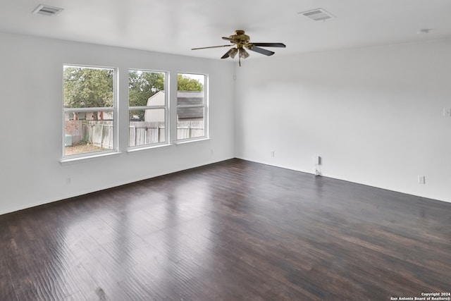 spare room featuring ceiling fan and dark hardwood / wood-style floors