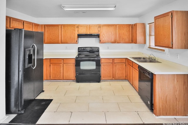 kitchen with light tile patterned floors, sink, and black appliances