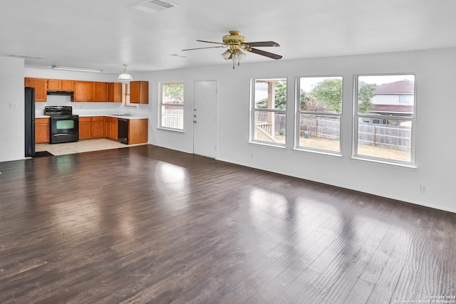 unfurnished living room featuring wood-type flooring and ceiling fan