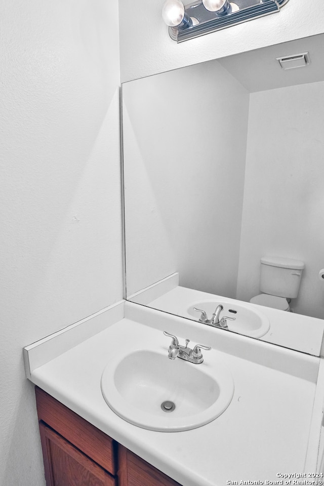 bathroom featuring vanity and toilet