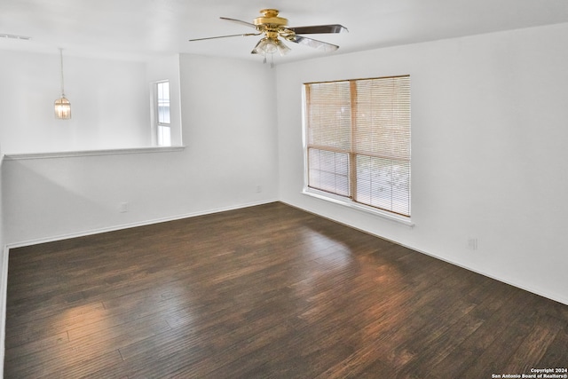 empty room featuring ceiling fan and dark hardwood / wood-style floors