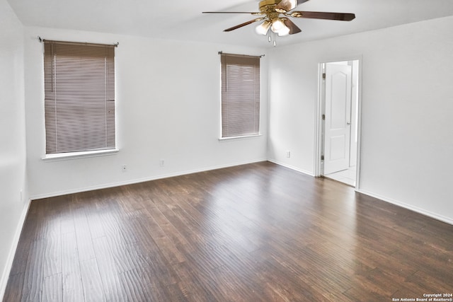 unfurnished room with dark hardwood / wood-style flooring and ceiling fan