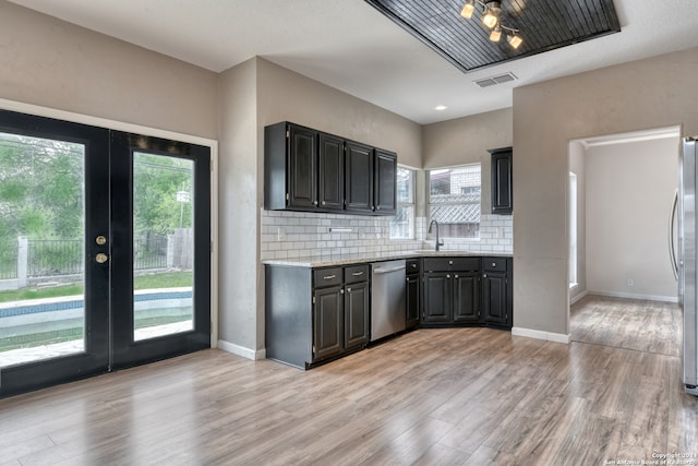 kitchen with appliances with stainless steel finishes, light hardwood / wood-style flooring, and plenty of natural light