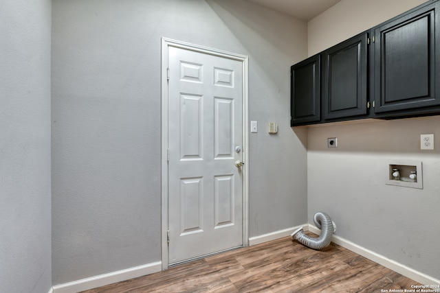 laundry area with cabinets, hardwood / wood-style flooring, electric dryer hookup, and washer hookup