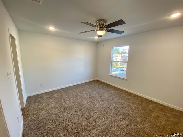 spare room with carpet floors and ceiling fan