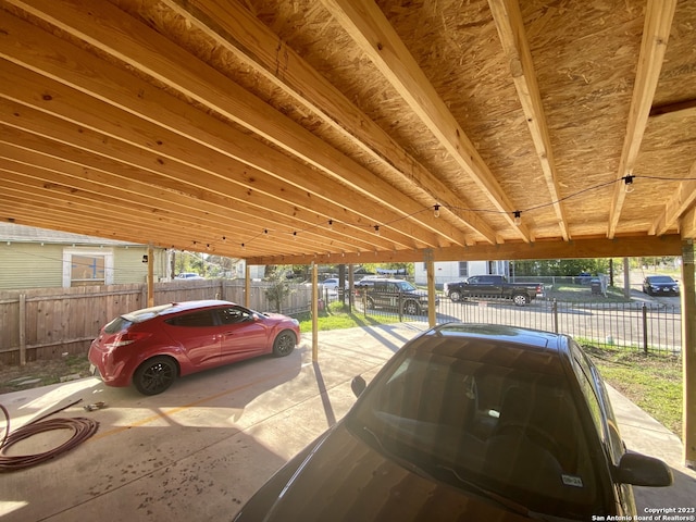 view of parking / parking lot featuring a carport