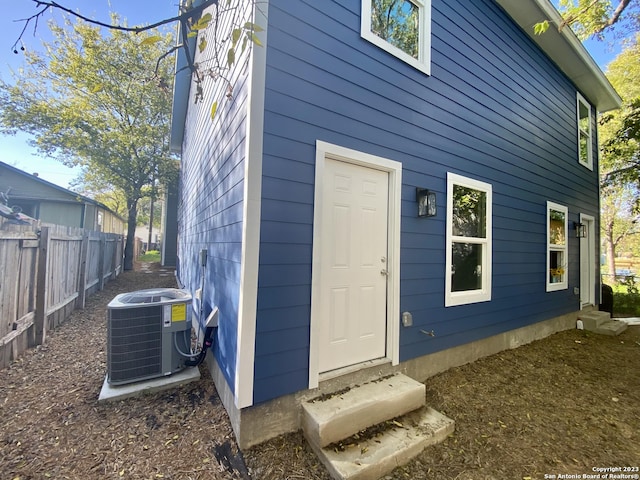 rear view of property with central AC unit