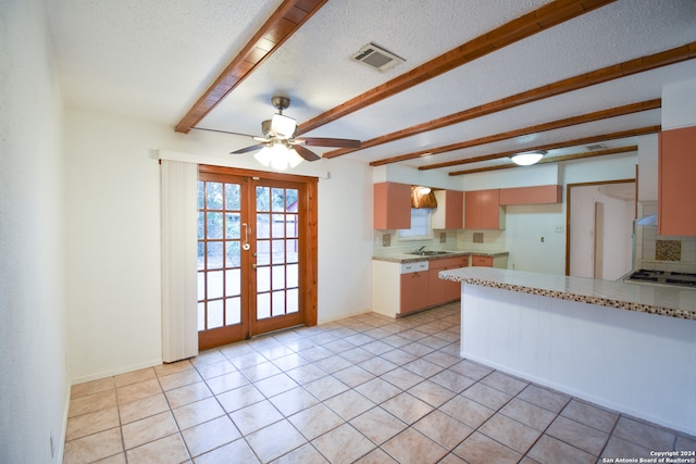 kitchen with beam ceiling, light tile patterned floors, french doors, and tasteful backsplash