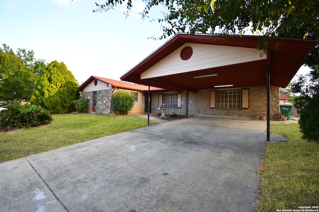 view of front of house with a front lawn and a carport