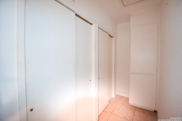 corridor with light tile patterned flooring