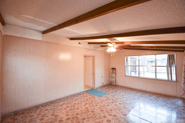 empty room with a textured ceiling, ceiling fan, and beam ceiling