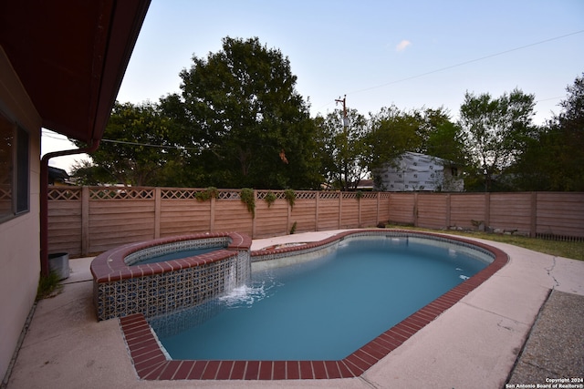 view of swimming pool with an in ground hot tub