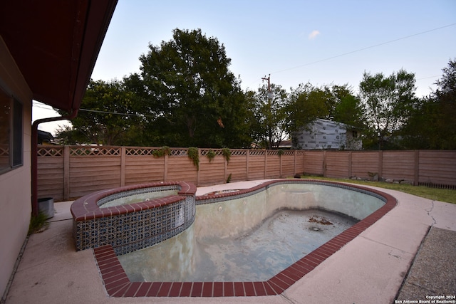 view of swimming pool featuring an in ground hot tub