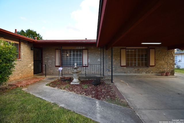 view of exterior entry with covered porch