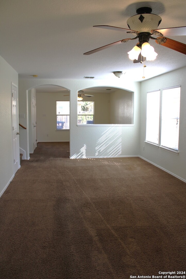 unfurnished room featuring ceiling fan and carpet floors