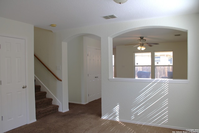 interior space with ceiling fan