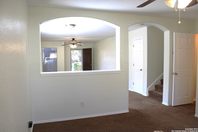 carpeted spare room featuring ceiling fan