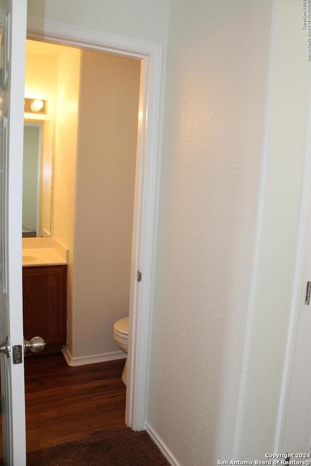 bathroom featuring hardwood / wood-style floors, vanity, and toilet