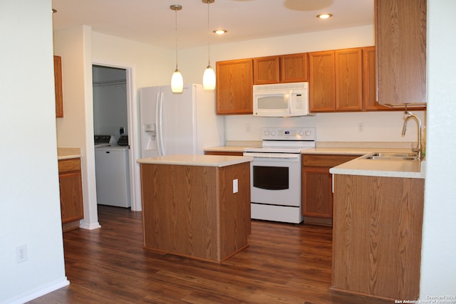 kitchen featuring sink, washer / clothes dryer, hanging light fixtures, white appliances, and dark hardwood / wood-style flooring