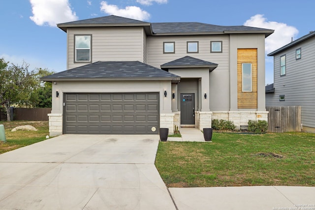 view of front of home with a garage and a front lawn