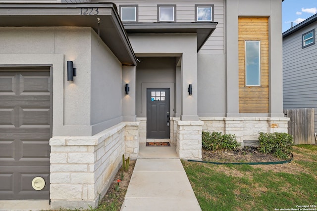 view of exterior entry featuring a garage