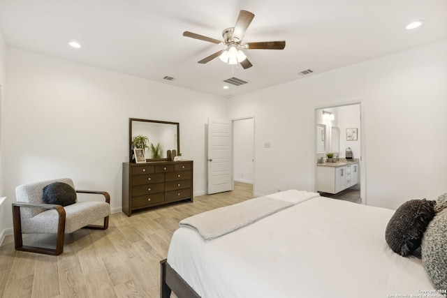 bedroom with ensuite bathroom, ceiling fan, and light hardwood / wood-style floors