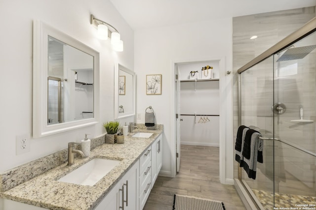 bathroom with vanity, an enclosed shower, and hardwood / wood-style floors