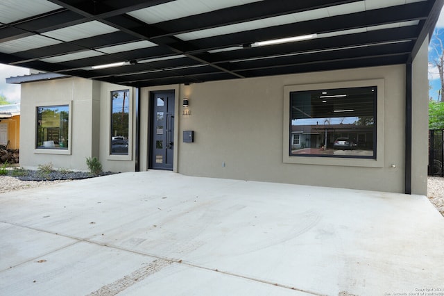 view of exterior entry featuring a carport