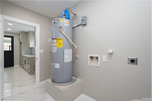 utility room featuring water heater and sink